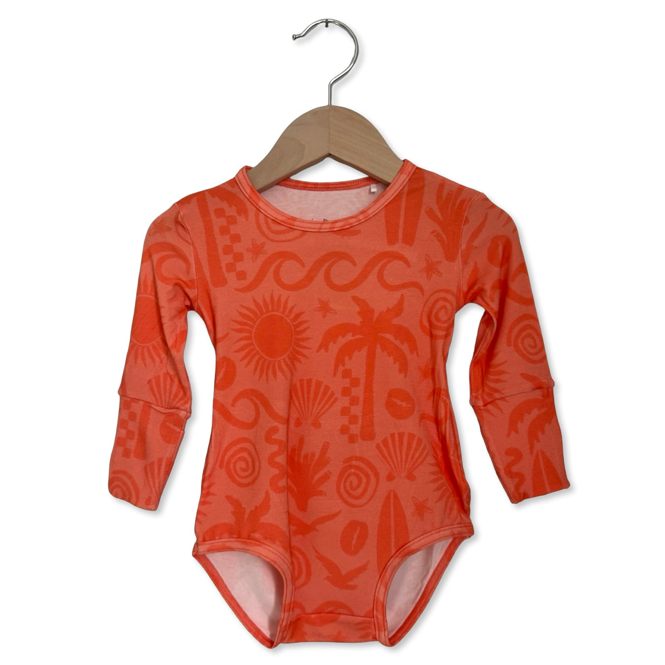 Orange patterned baby onesie on a hanger against a white background