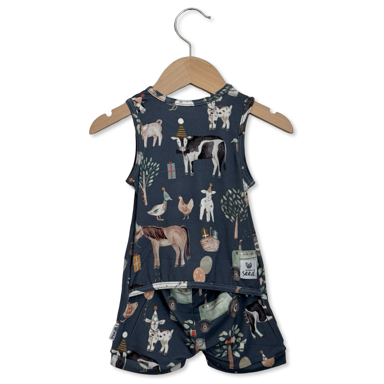 Children's sleeveless top and shorts set with farm animal pattern on a hanger against a white background.