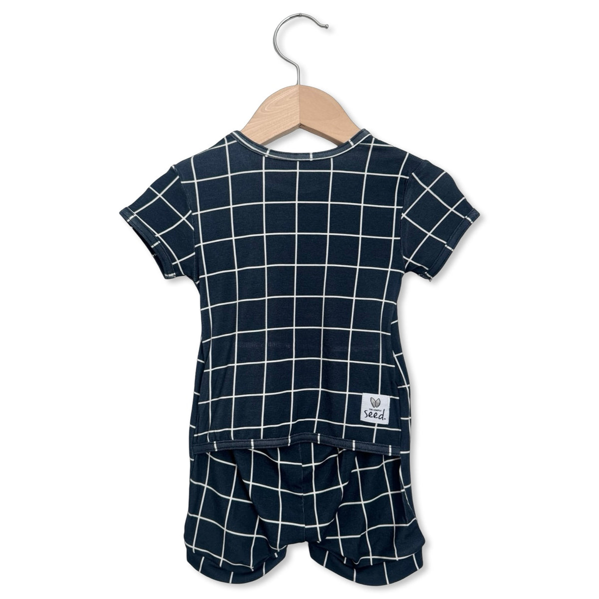 Children's navy blue and white checkered outfit on a hanger with a white background