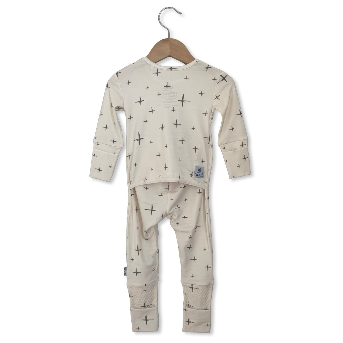 Children's pajama set with star pattern on a hanger against a white background
