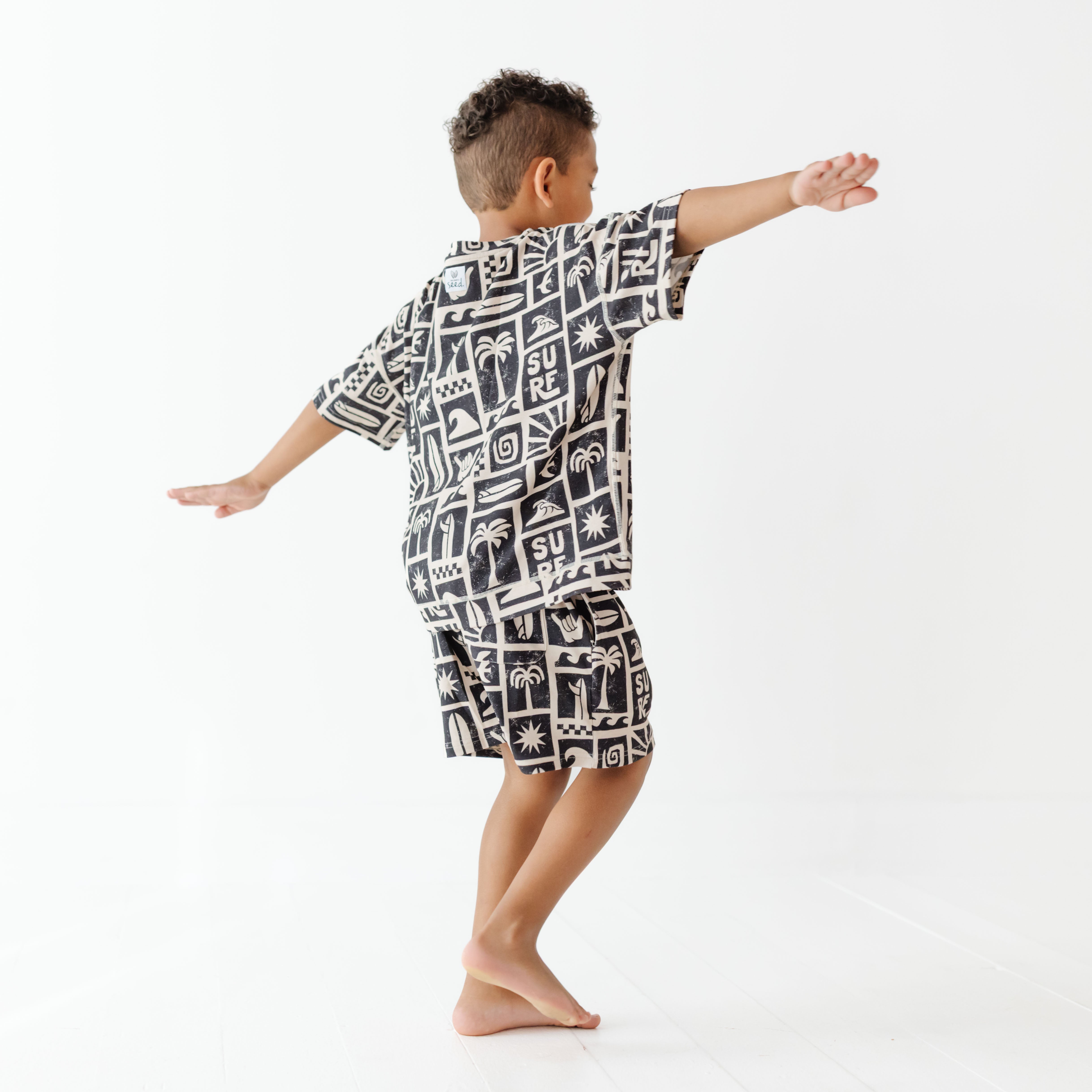Child wearing a black and white patterned outfit on a white background