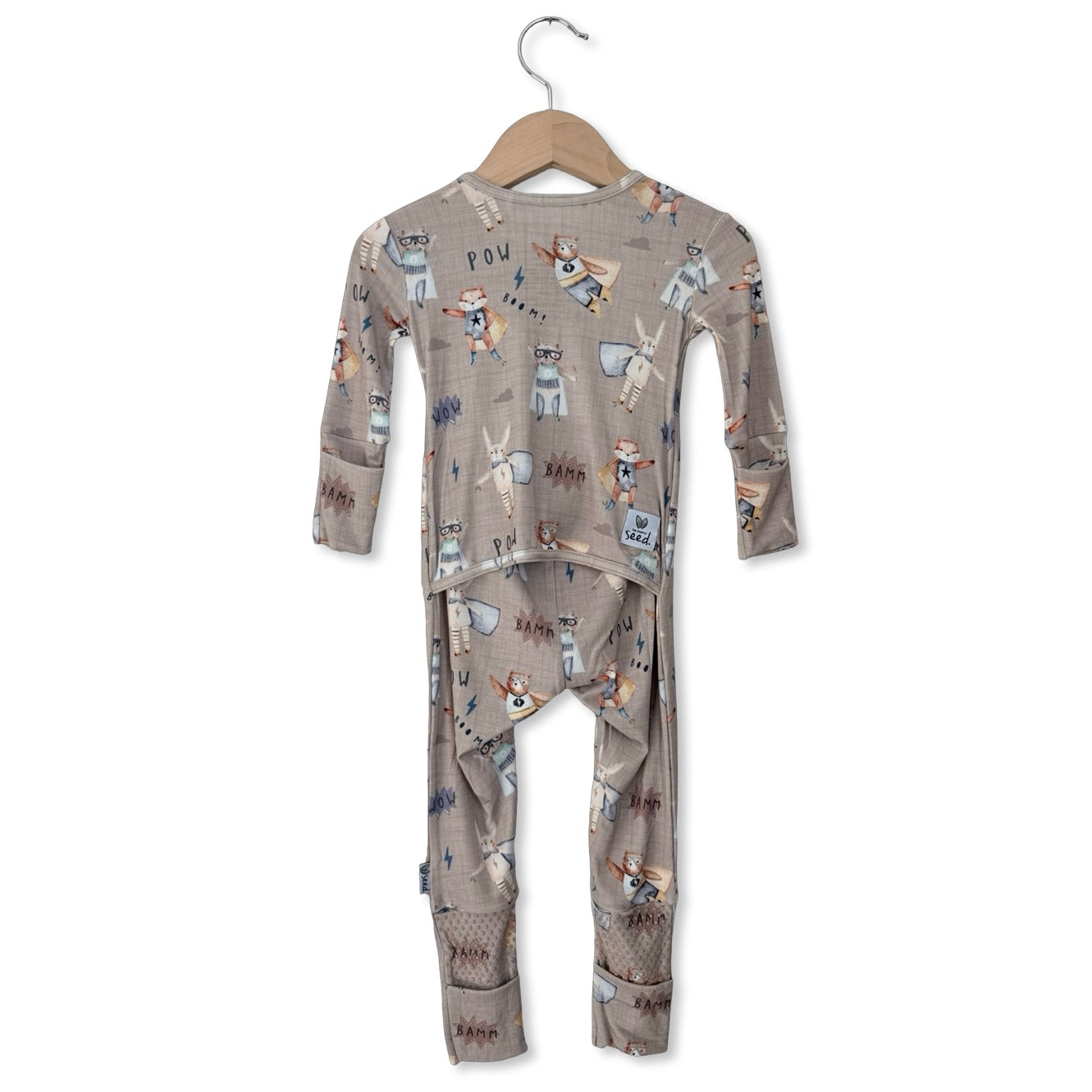 Children's pajama set with animal pattern on a hanger against a white background