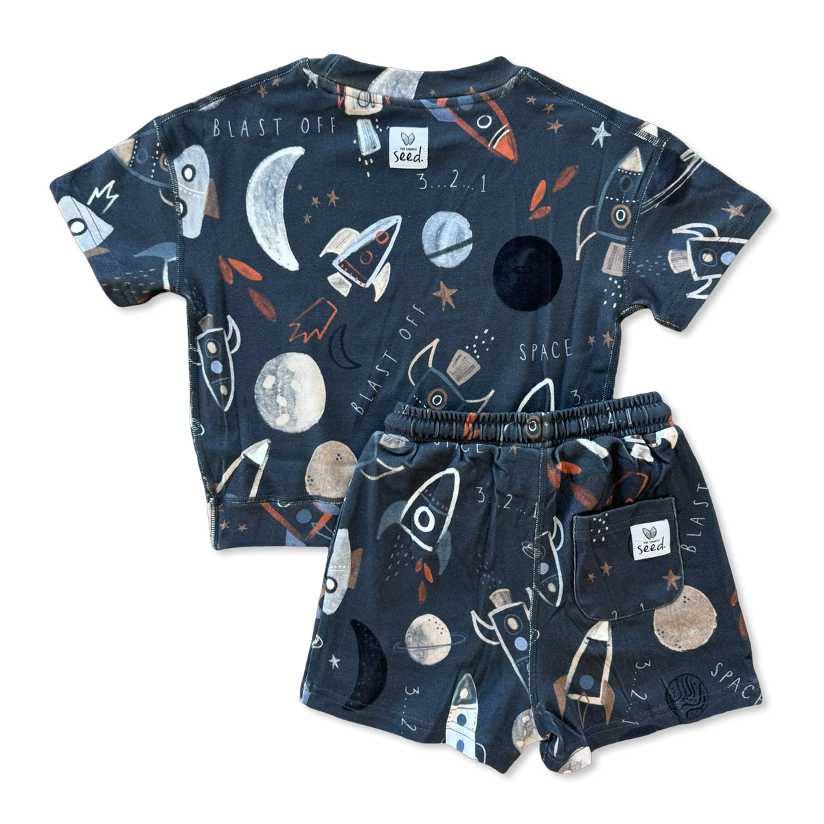 A two-piece kids' outfit set consisting of a short-sleeve t-shirt and matching shorts, both in a dark navy blue color with a playful space-themed print featuring rockets, planets, stars, and the words 'BLAST OFF' and 'SPACE'.