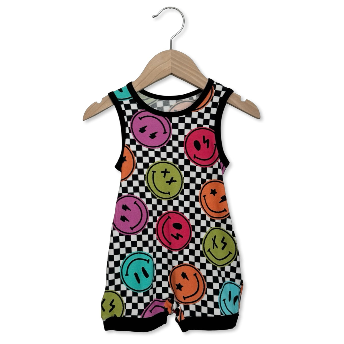 Children's sleeveless romper with smiley face pattern on a hanger against a white background