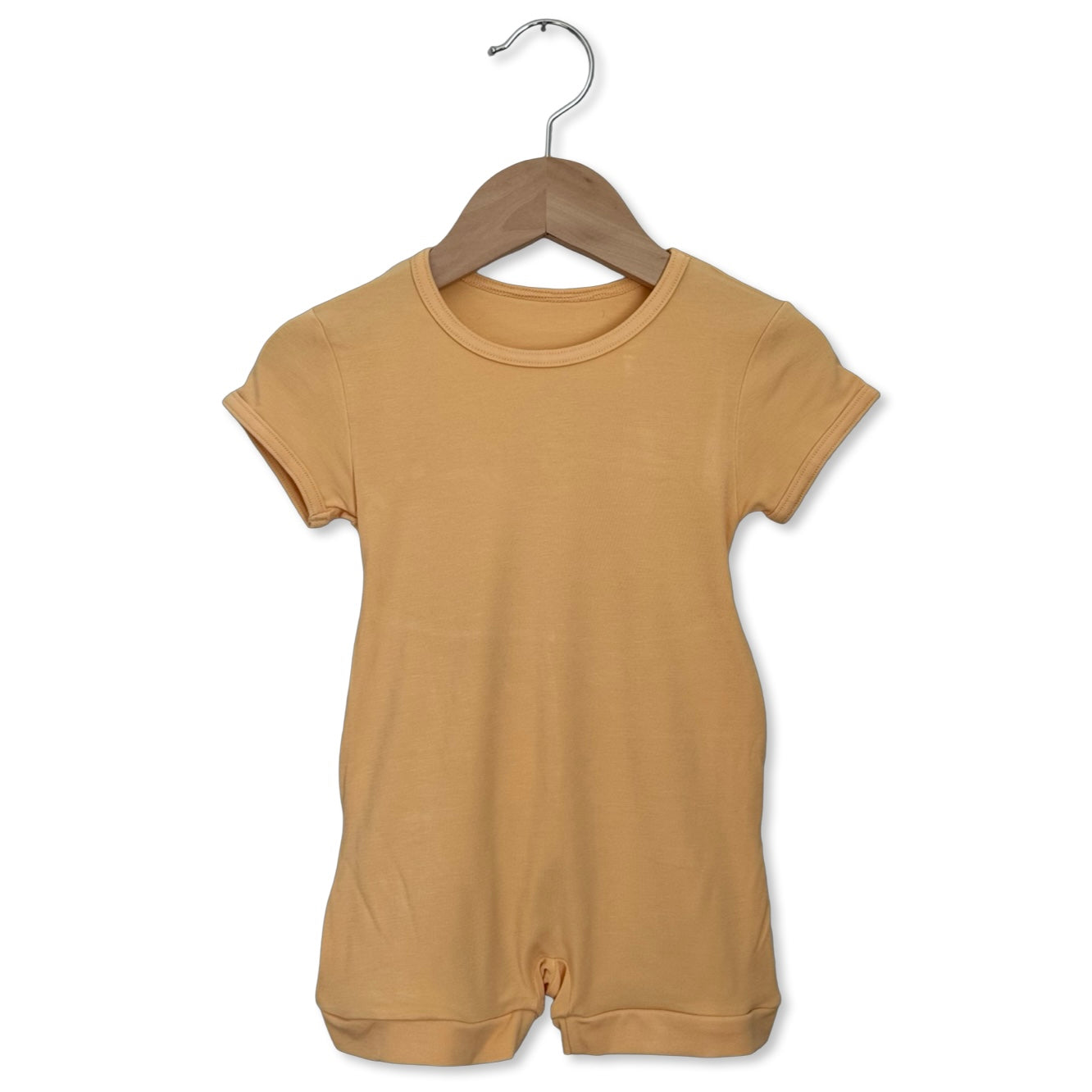 Brown baby romper on a hanger against a white background