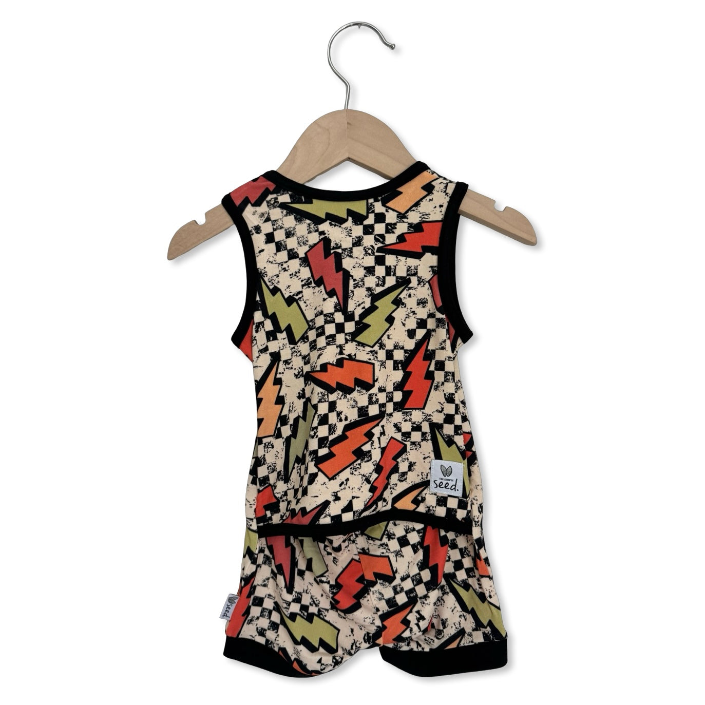 Baby romper with checkered and lightning bolt pattern on a hanger against a white background