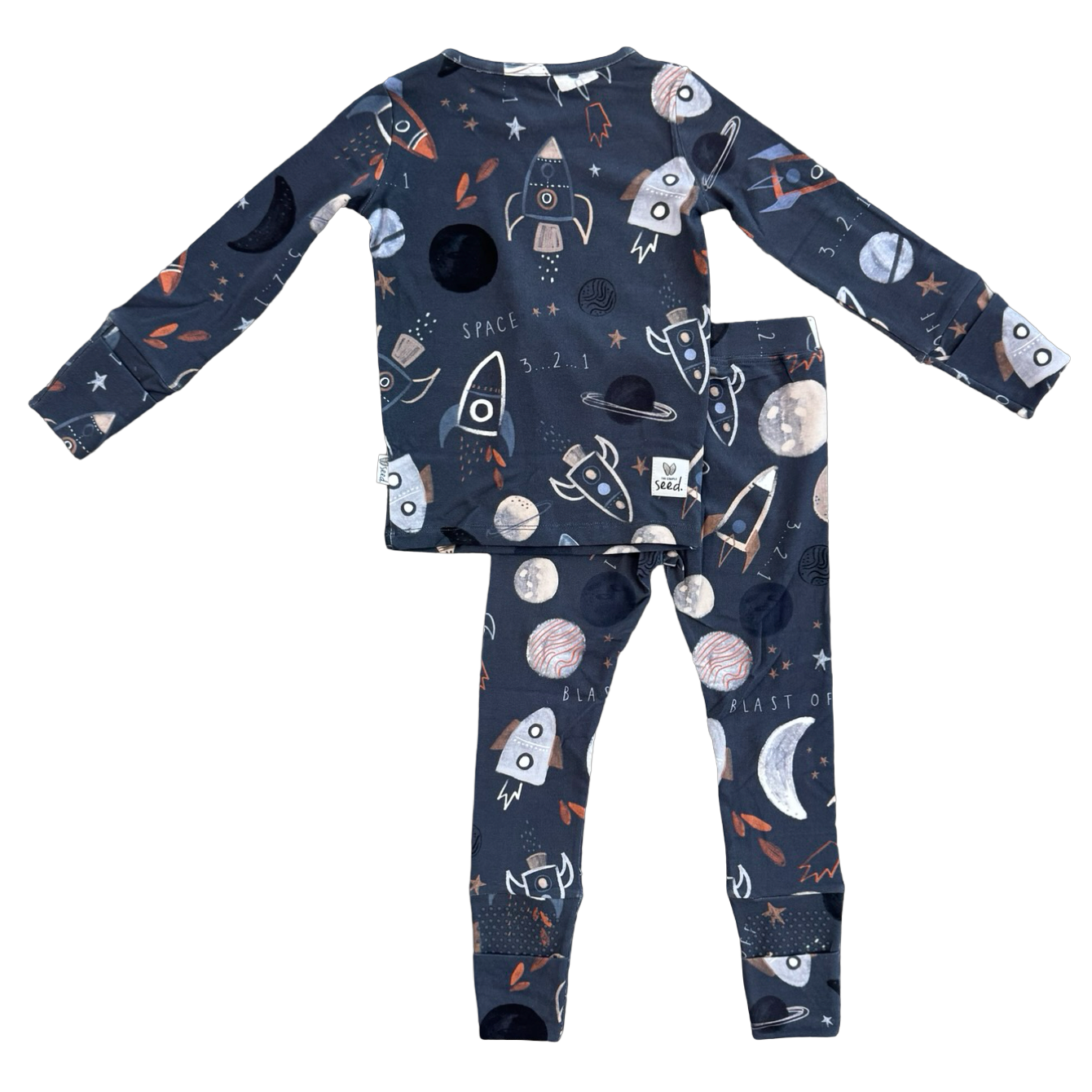 A two-piece children's pajama set featuring a long-sleeve top and matching pants in dark navy blue with a playful space-themed print of rockets, moons, planets, and stars.