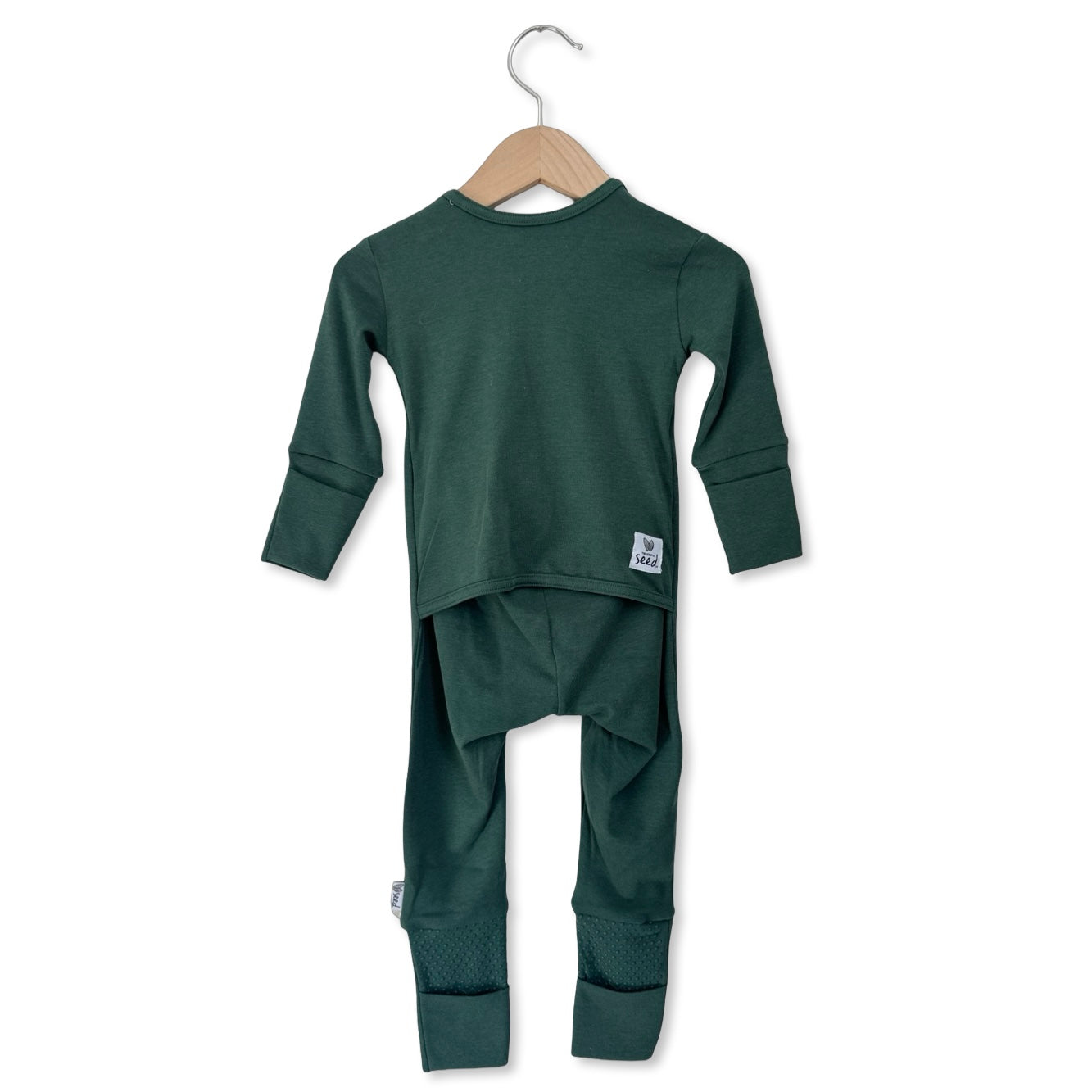 Green children's outfit with long-sleeve top and pants on a hanger against a white background