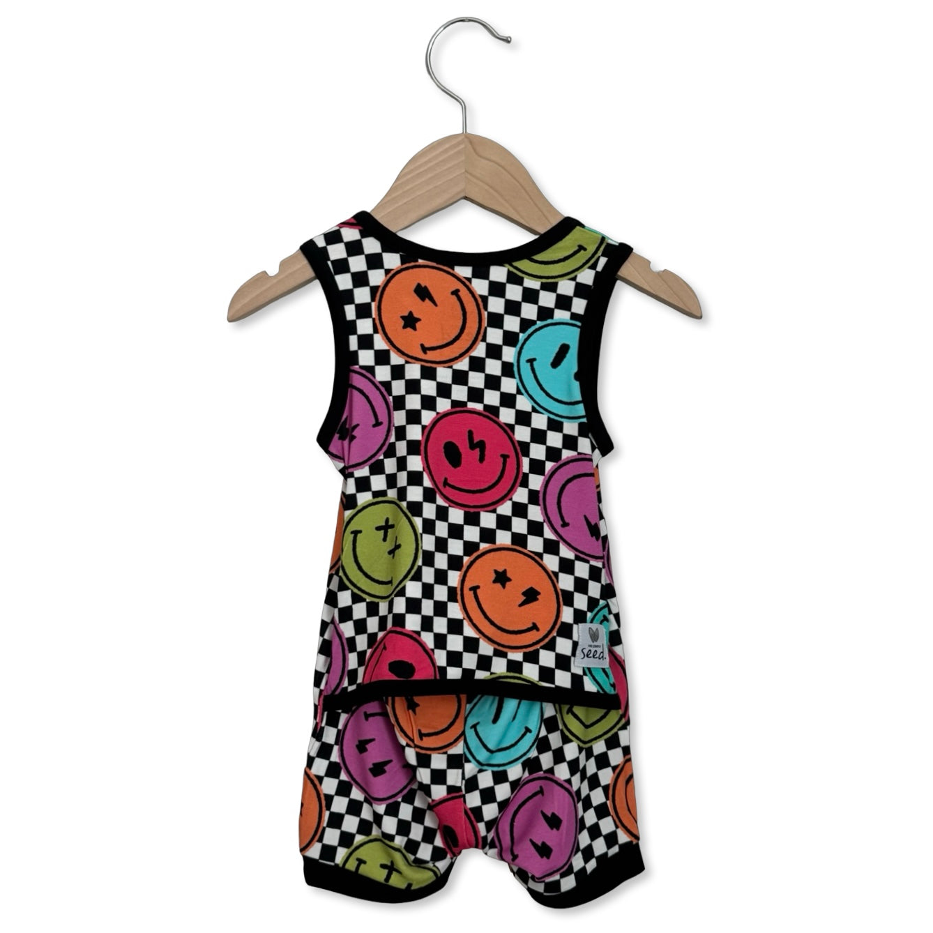 Children's romper with smiley face pattern on a hanger against a white background