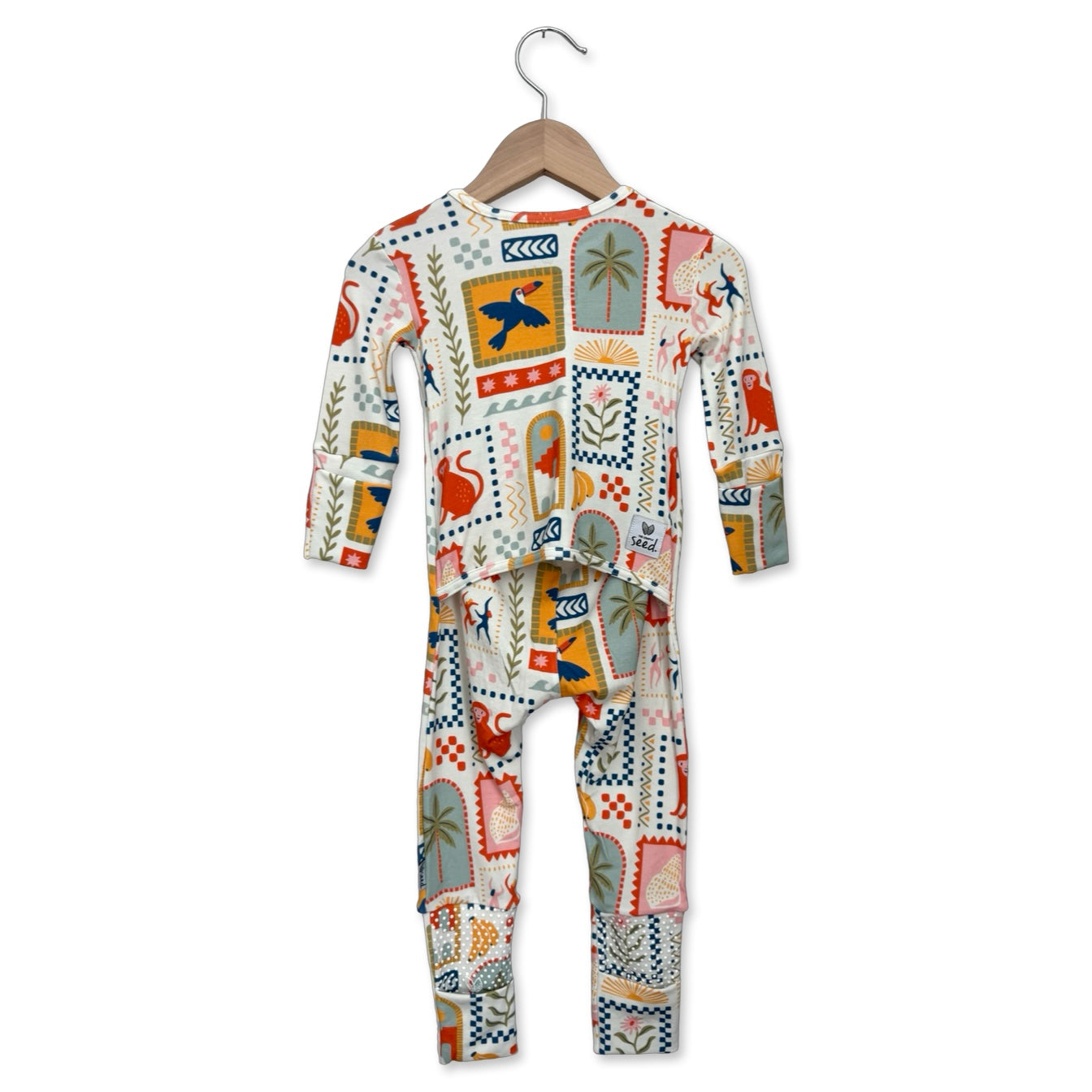 Children's onesie with a colorful pattern on a hanger against a white background
