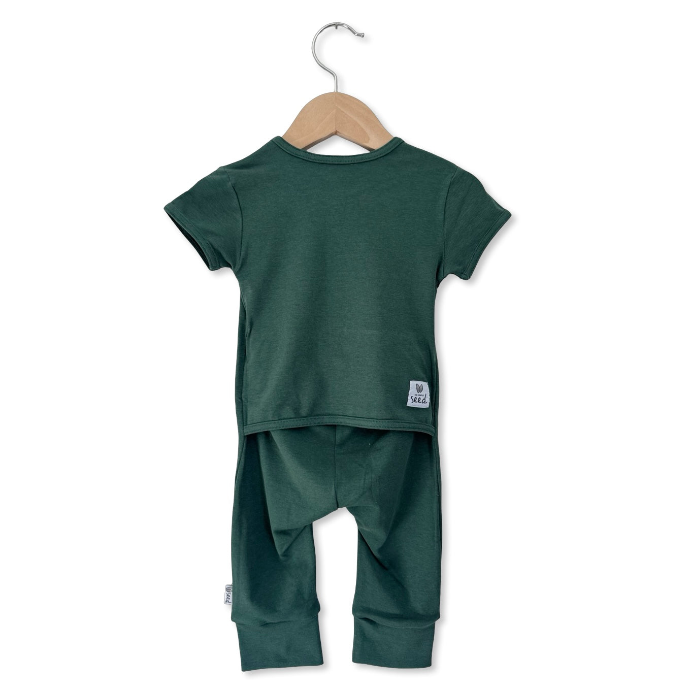 Green children's t-shirt and pants set on a hanger against a white background