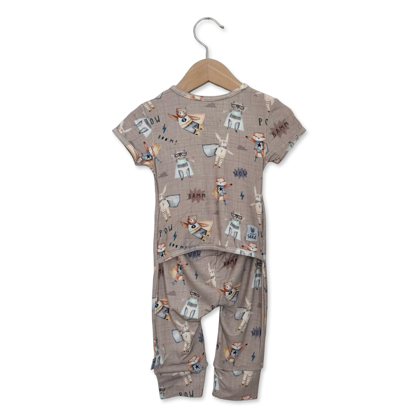 Children's pajama set with animal print on a hanger against a white background