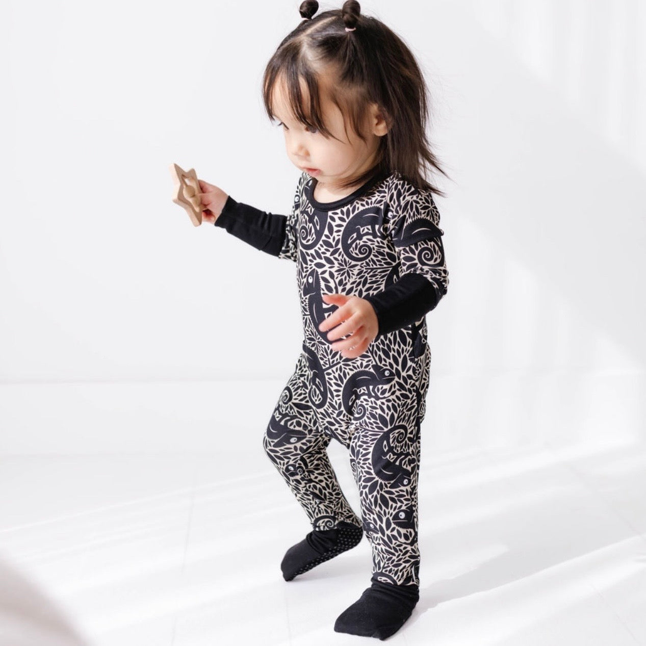Child wearing a black and white patterned outfit on a white background
