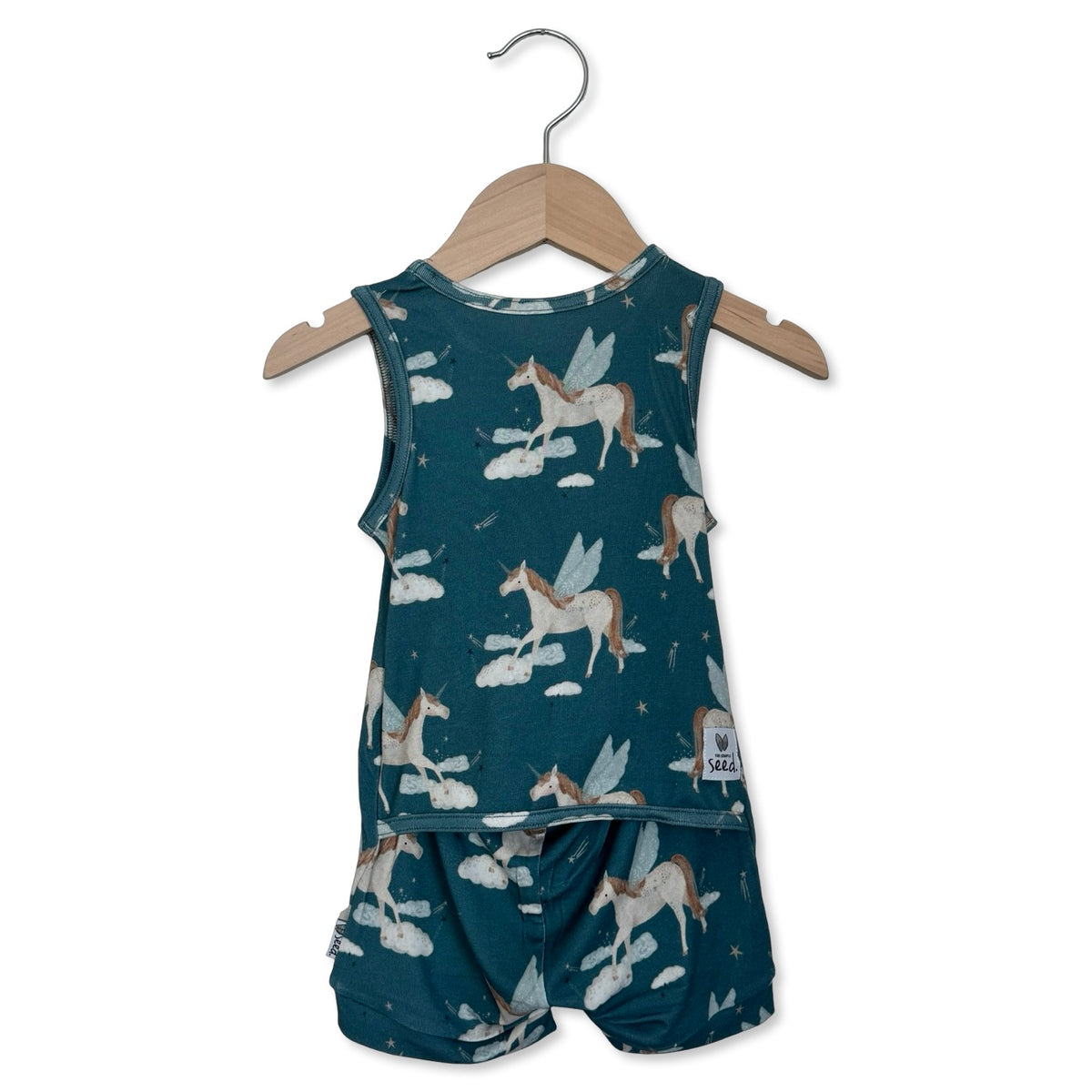 Children's romper with unicorn pattern on a hanger against a white background