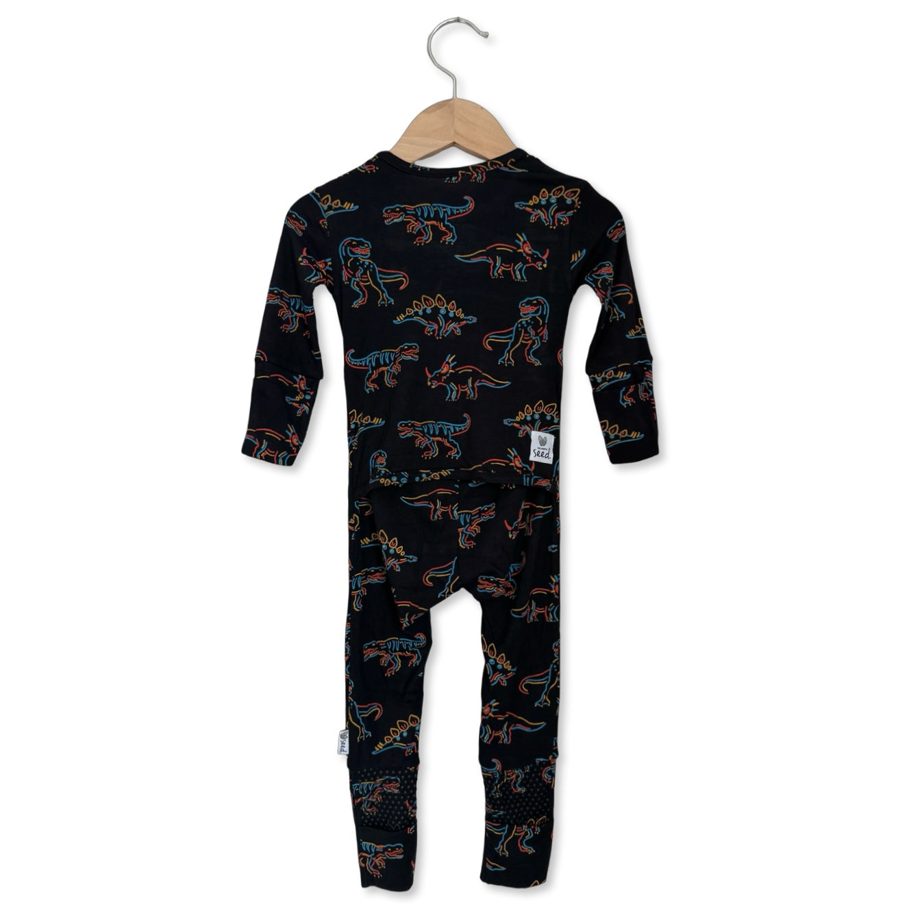 Black baby onesie with dinosaur pattern on a hanger against a white background