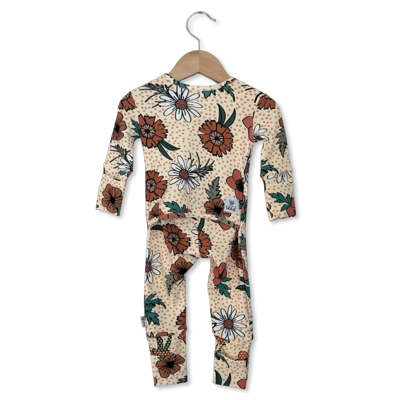 Floral-patterned baby onesie on a hanger against a white background