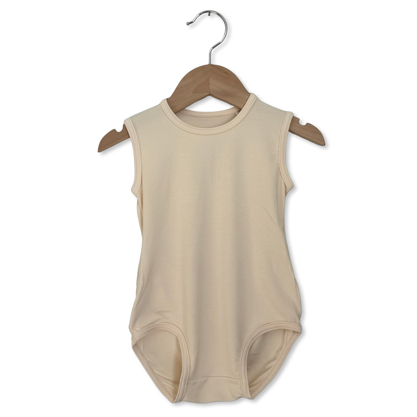 Beige sleeveless baby bodysuit on a wooden hanger against a white background