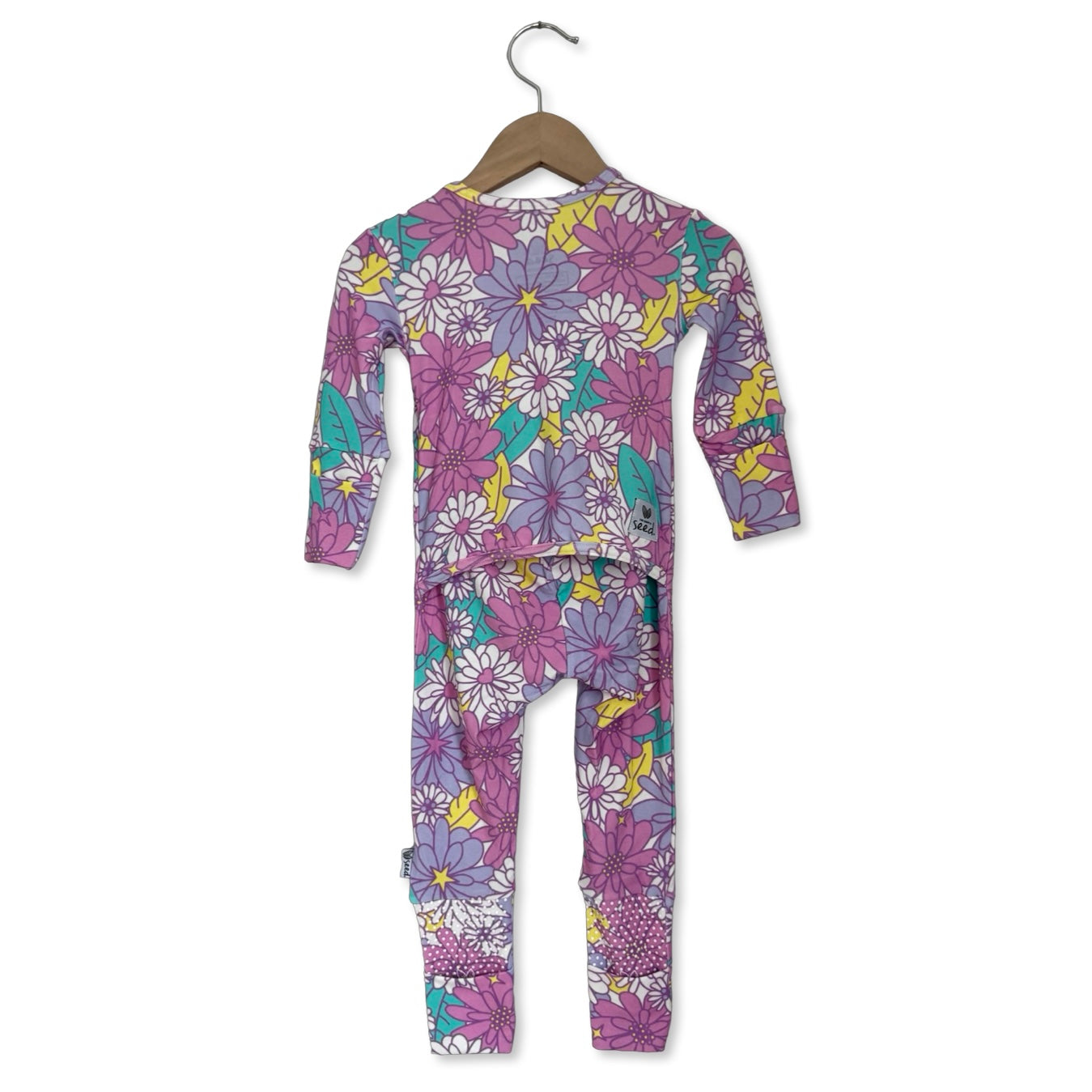 Children's floral onesie on a hanger against a white background