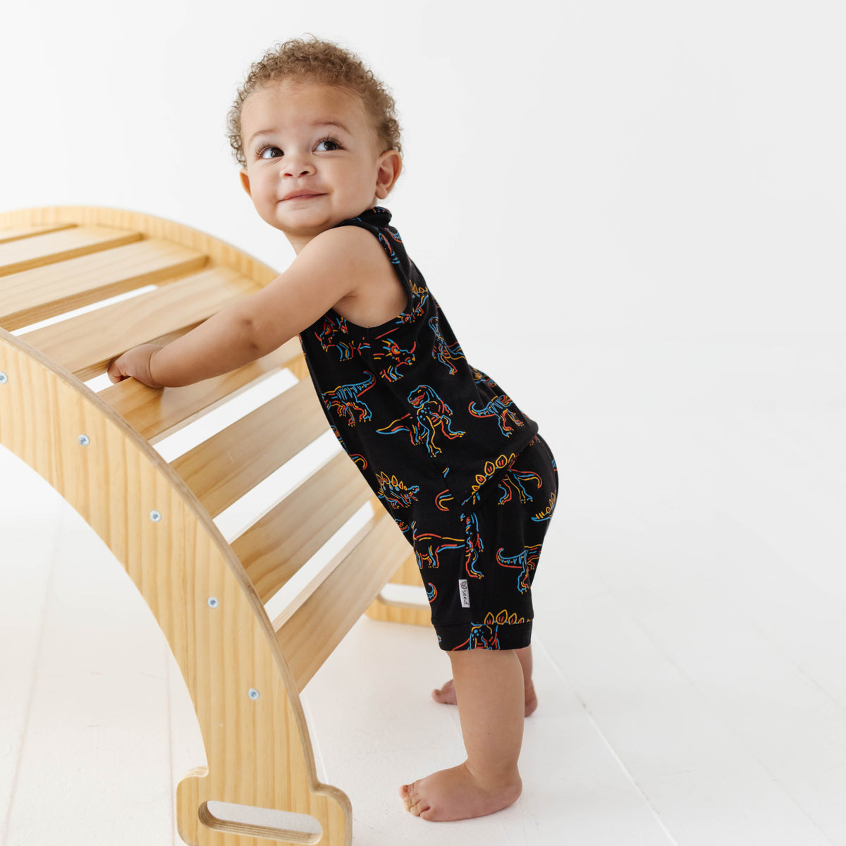 Child climbing a wooden ladder on a white background