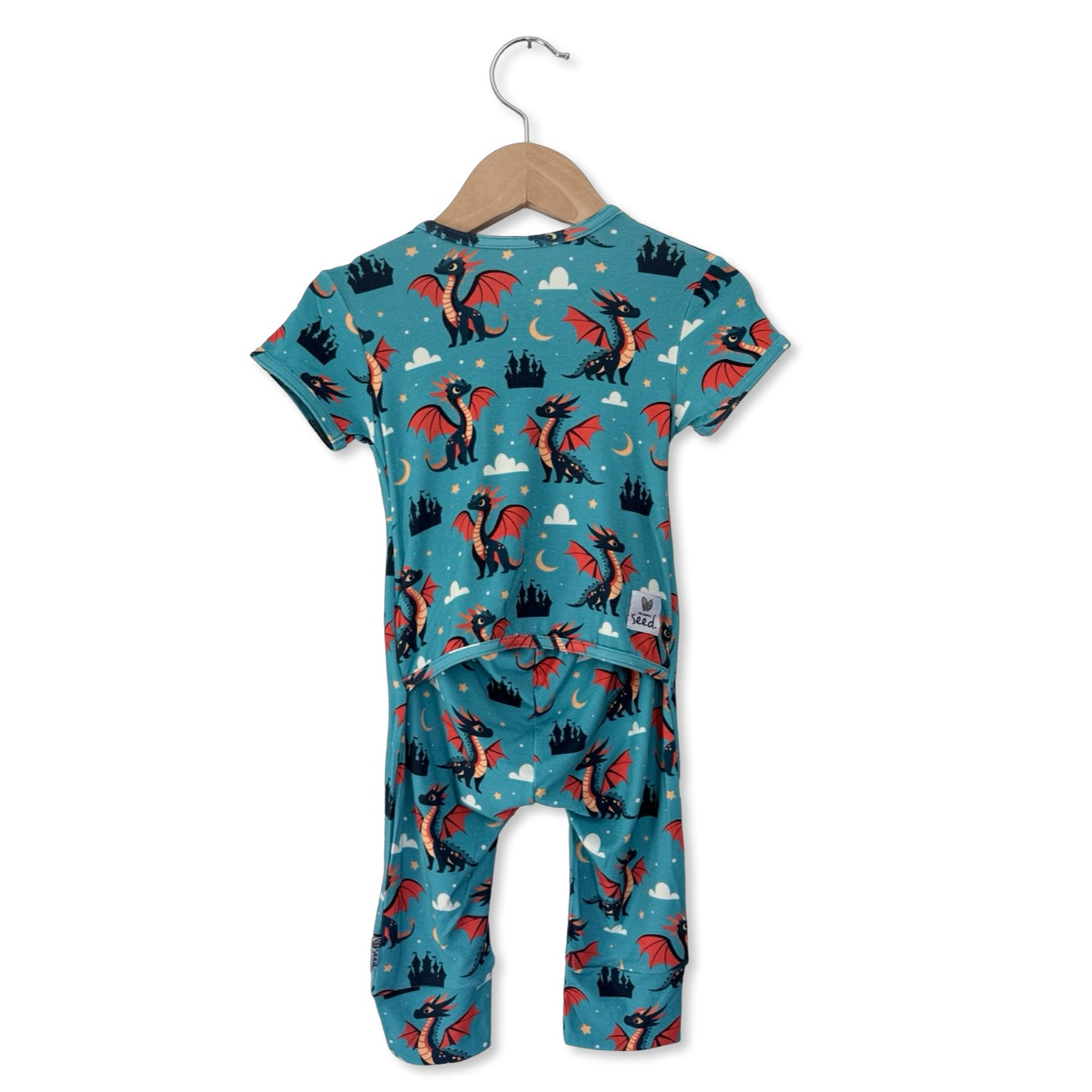 Children's onesie with dragon pattern on a hanger against a white background