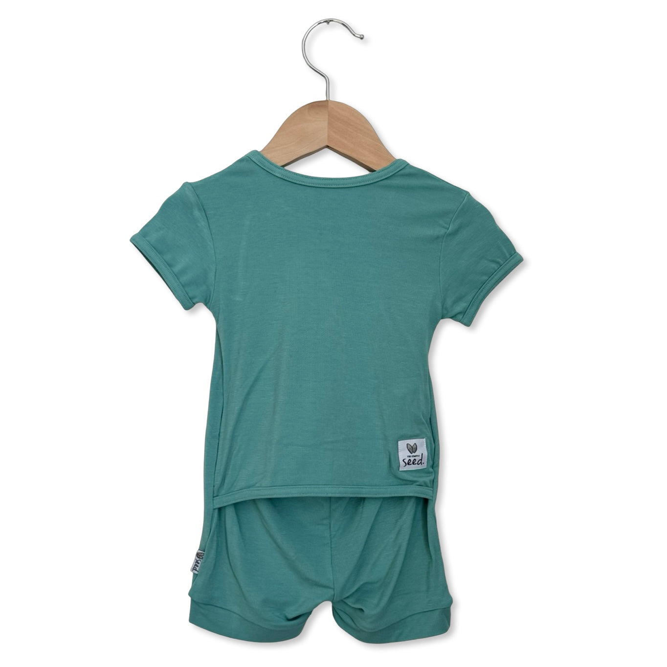 Teal children's outfit with shorts on a hanger against a white background