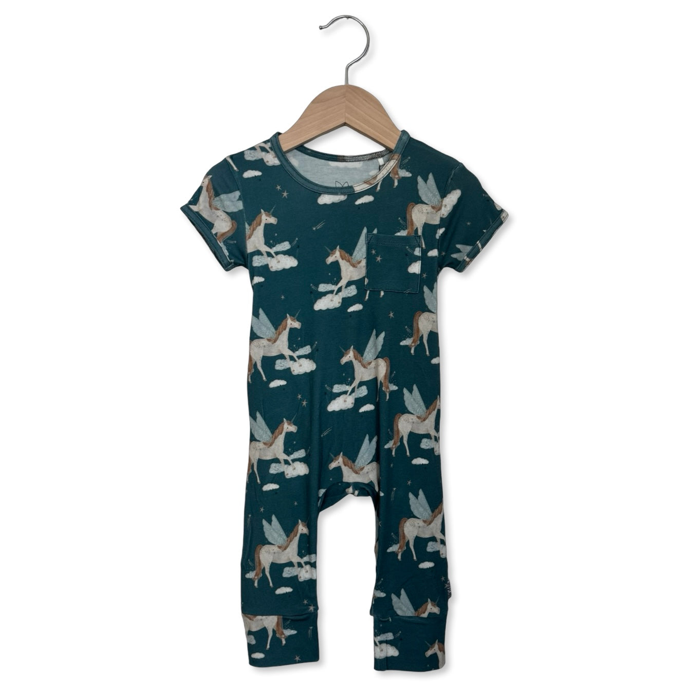 Children's onesie with fairy pattern on a hanger against a white background