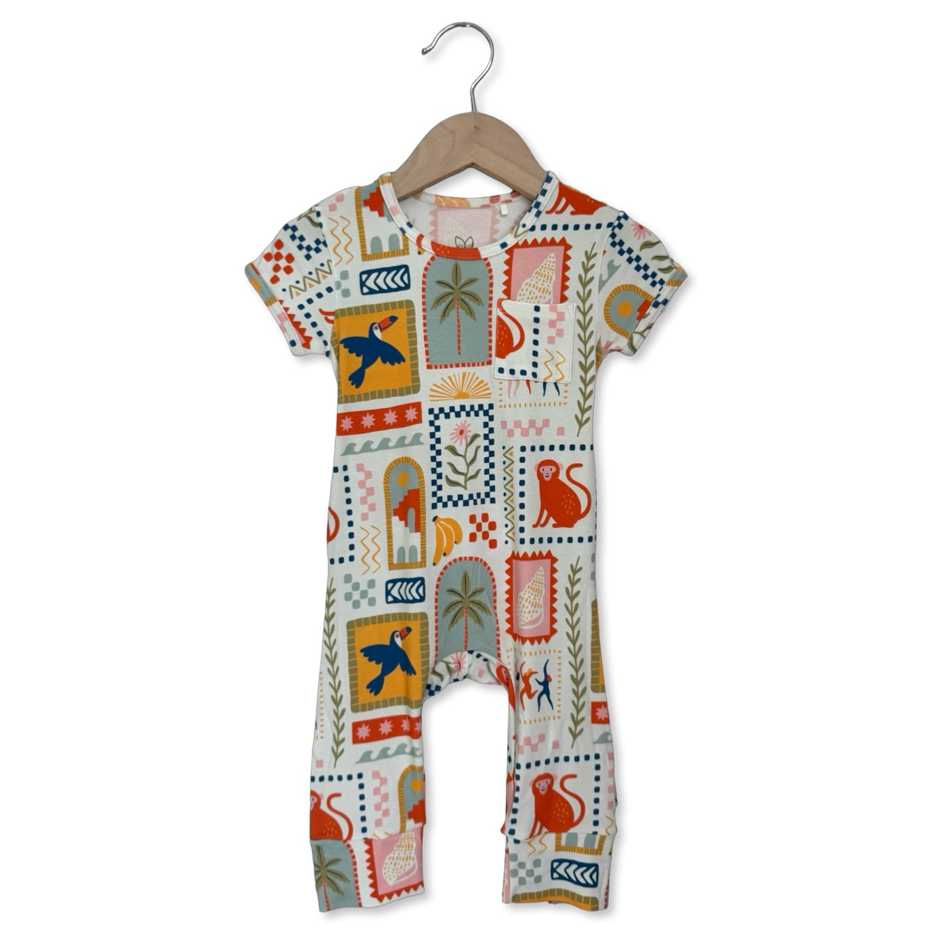 Baby romper with colorful geometric pattern on a hanger against a white background