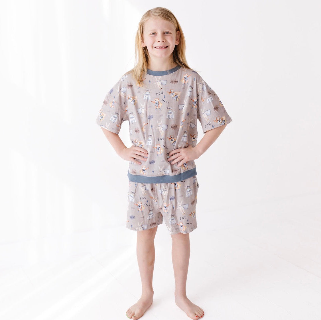 Young girl wearing a patterned pajama set on a white background