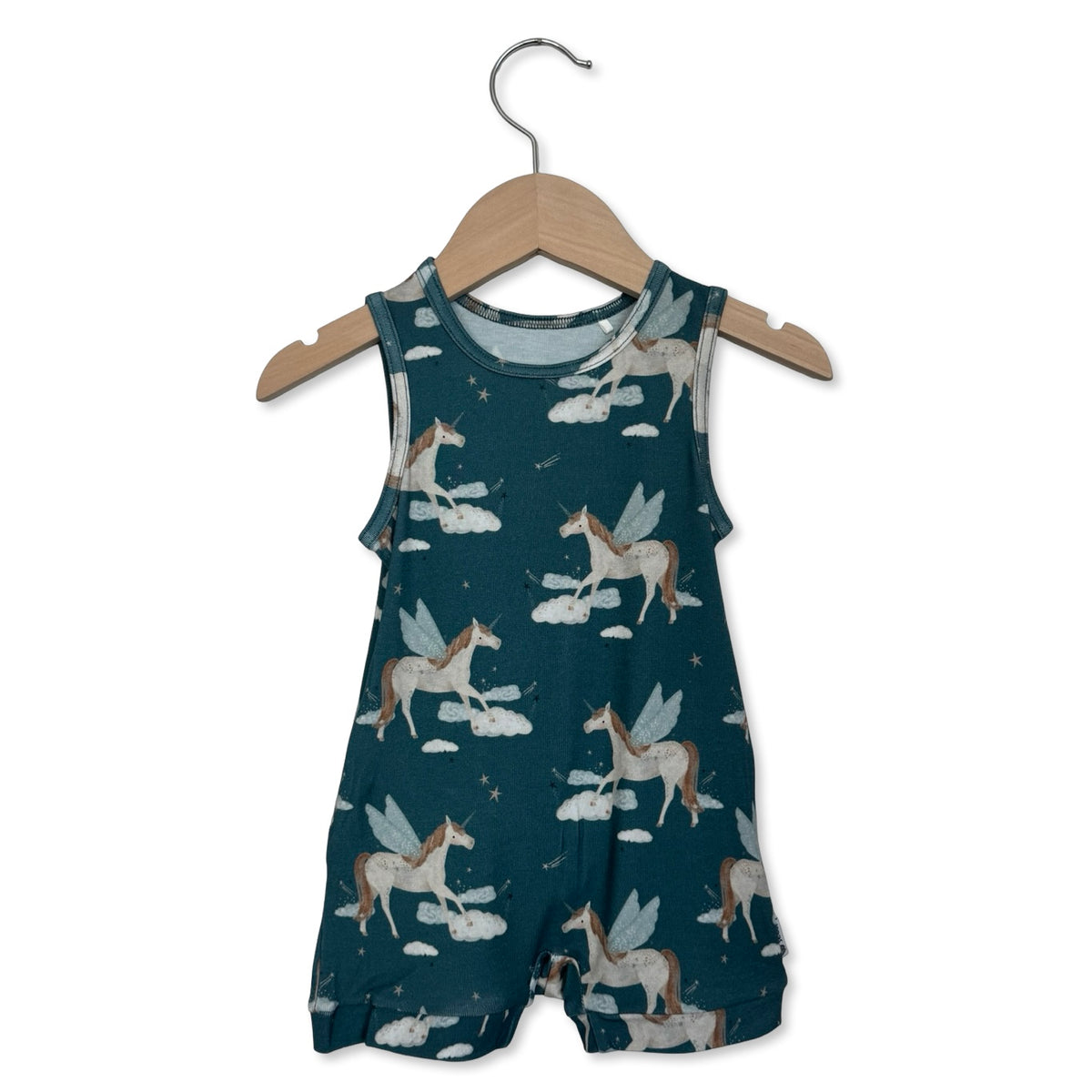 Children's romper with fairy and cloud pattern on a hanger against a white background