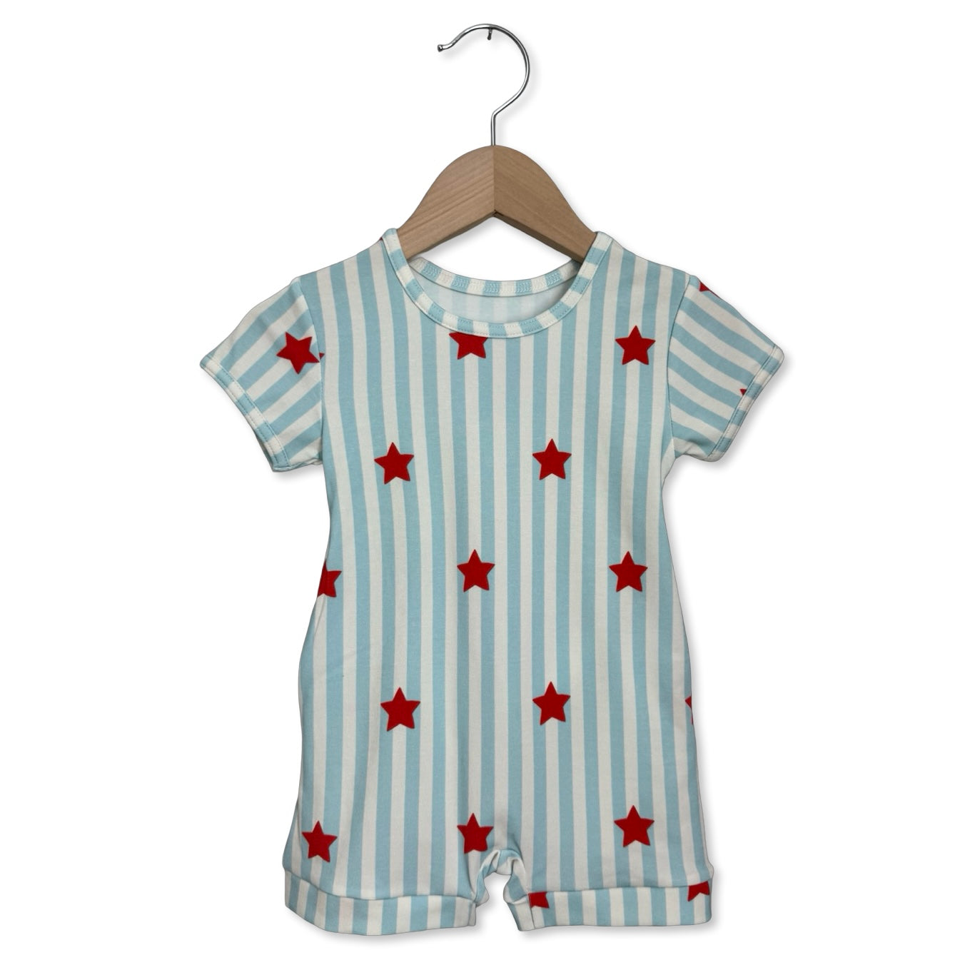 Baby romper with blue stripes and red stars on a hanger against a white background