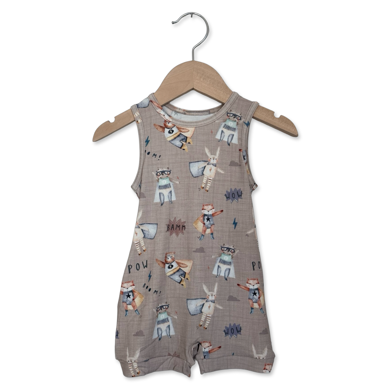 Baby romper with animal print on a hanger against a white background
