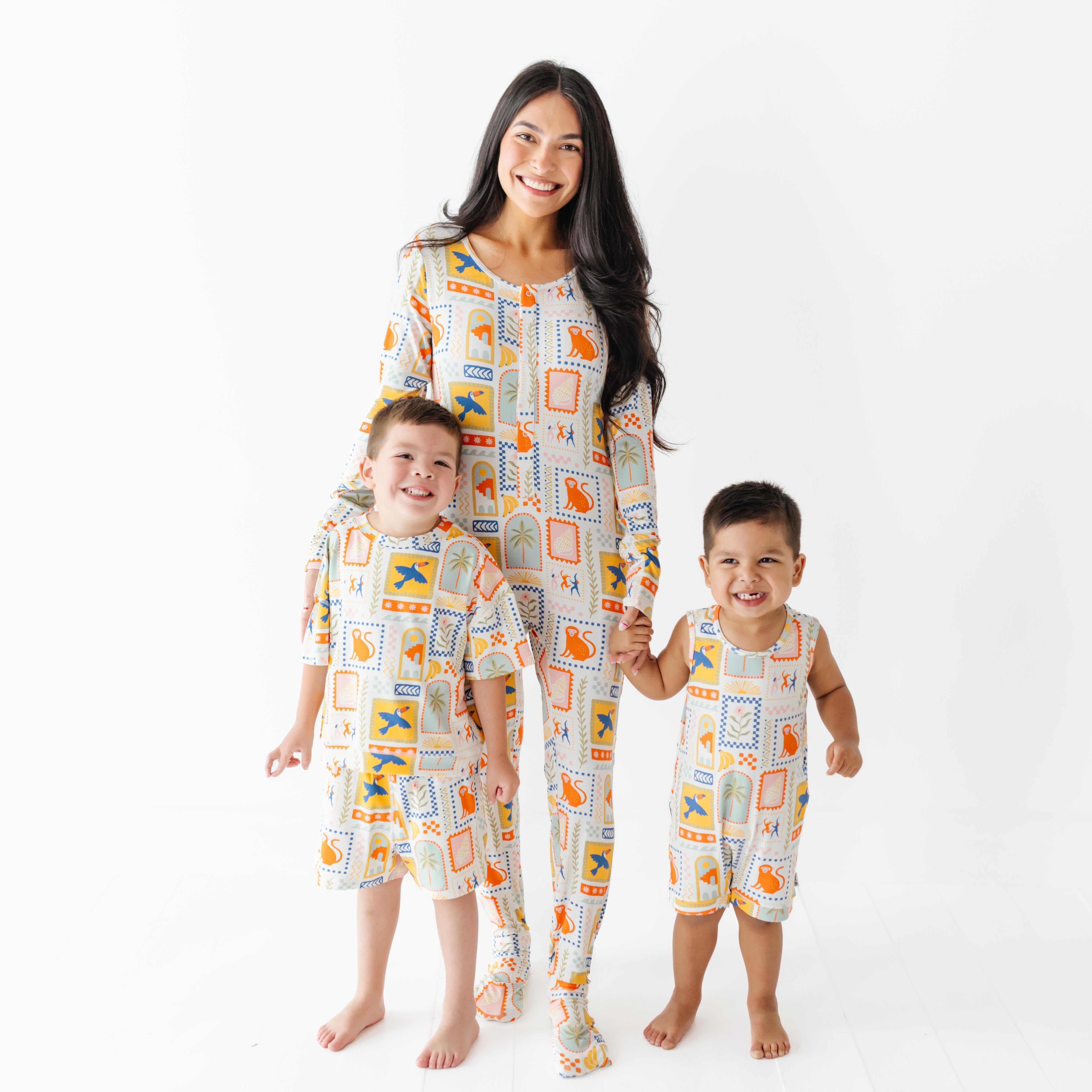 Woman and two children wearing matching pajamas with a geometric pattern on a white background