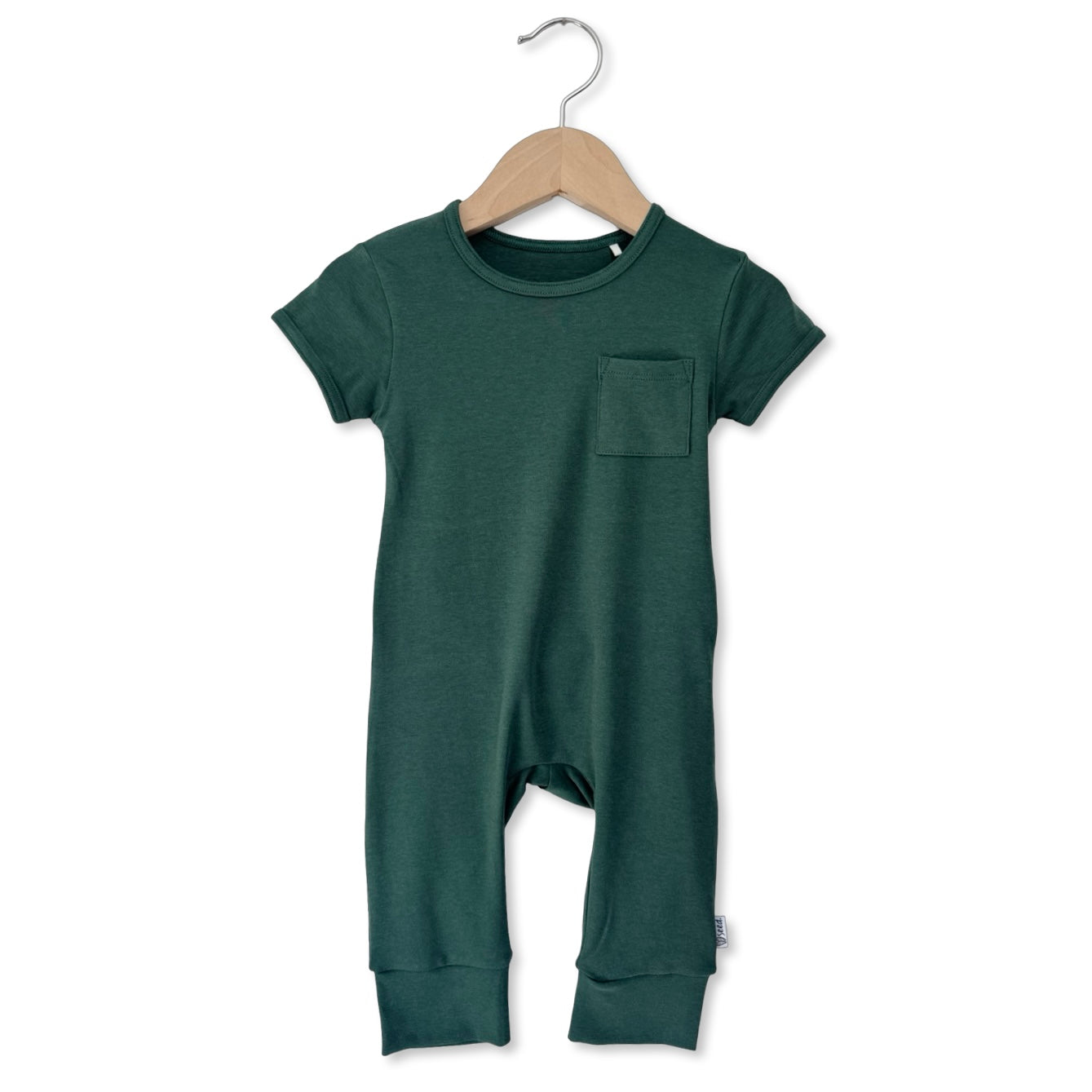 Green baby romper on a hanger against a white background