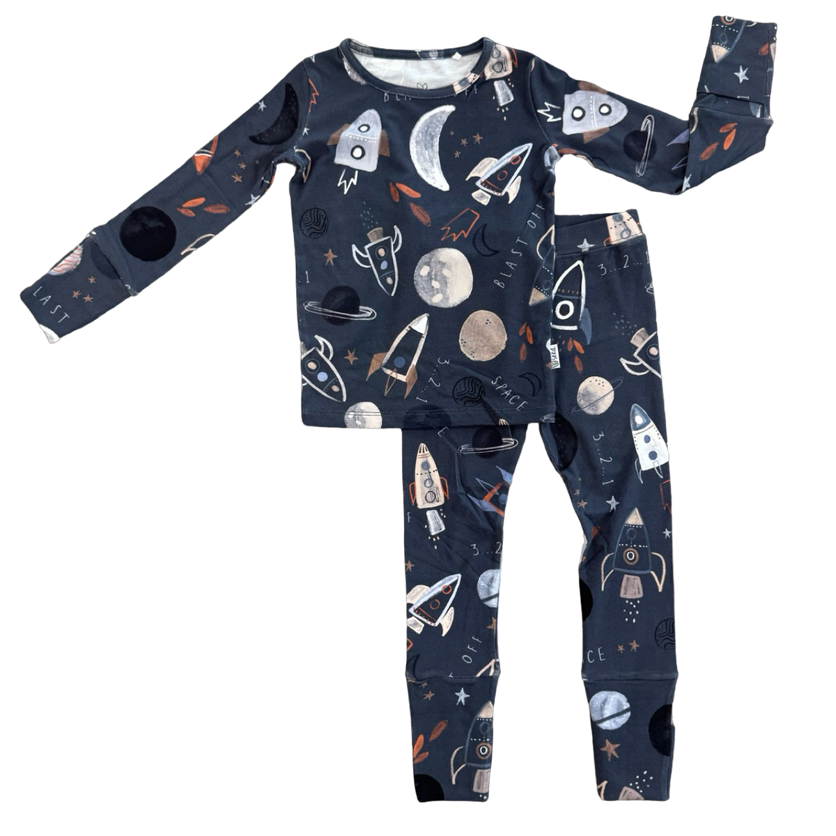 A two-piece children's pajama set featuring a long-sleeve top and matching pants in dark navy blue with a playful outer-space print of rockets, moons, planets, and stars.