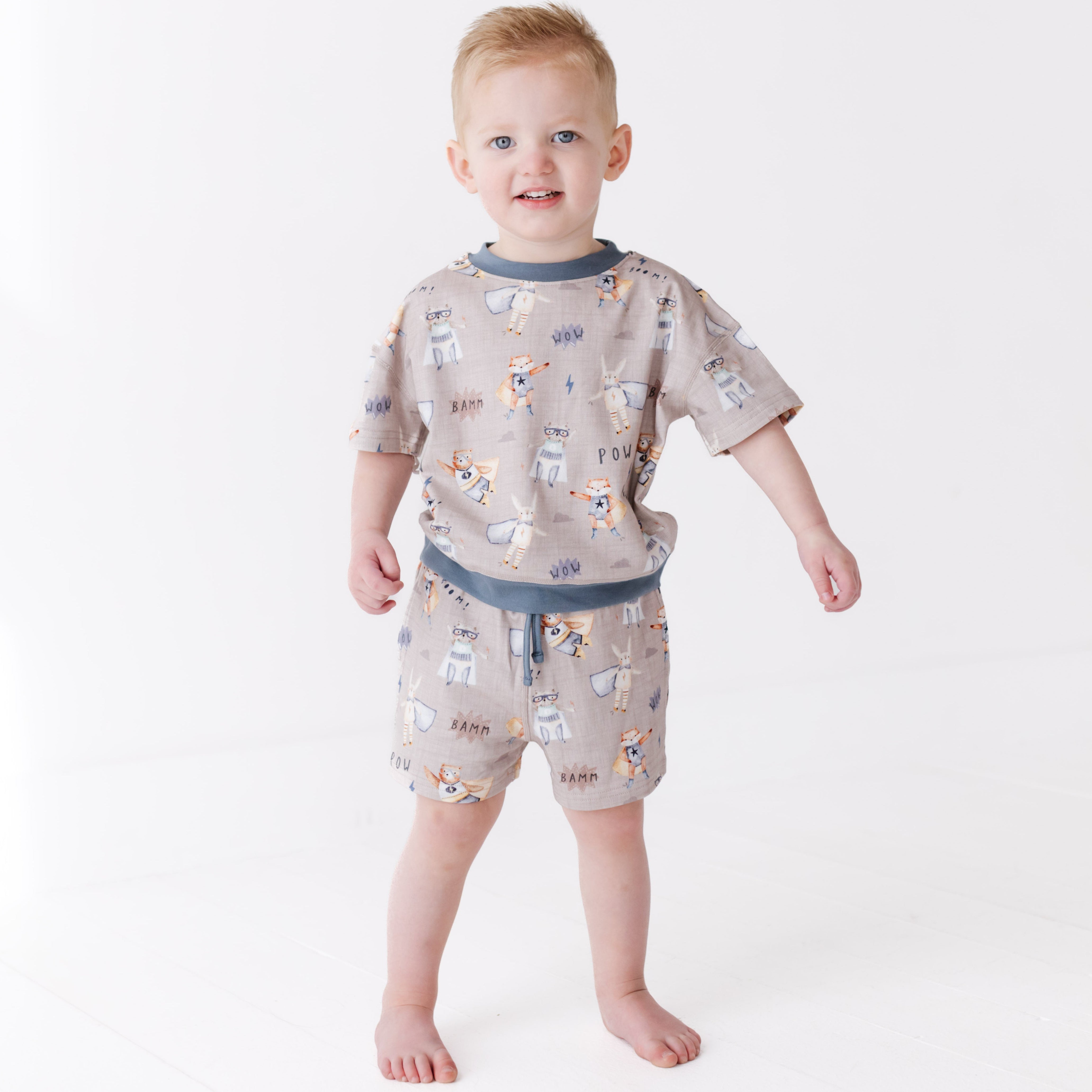Child wearing a patterned outfit on a white background