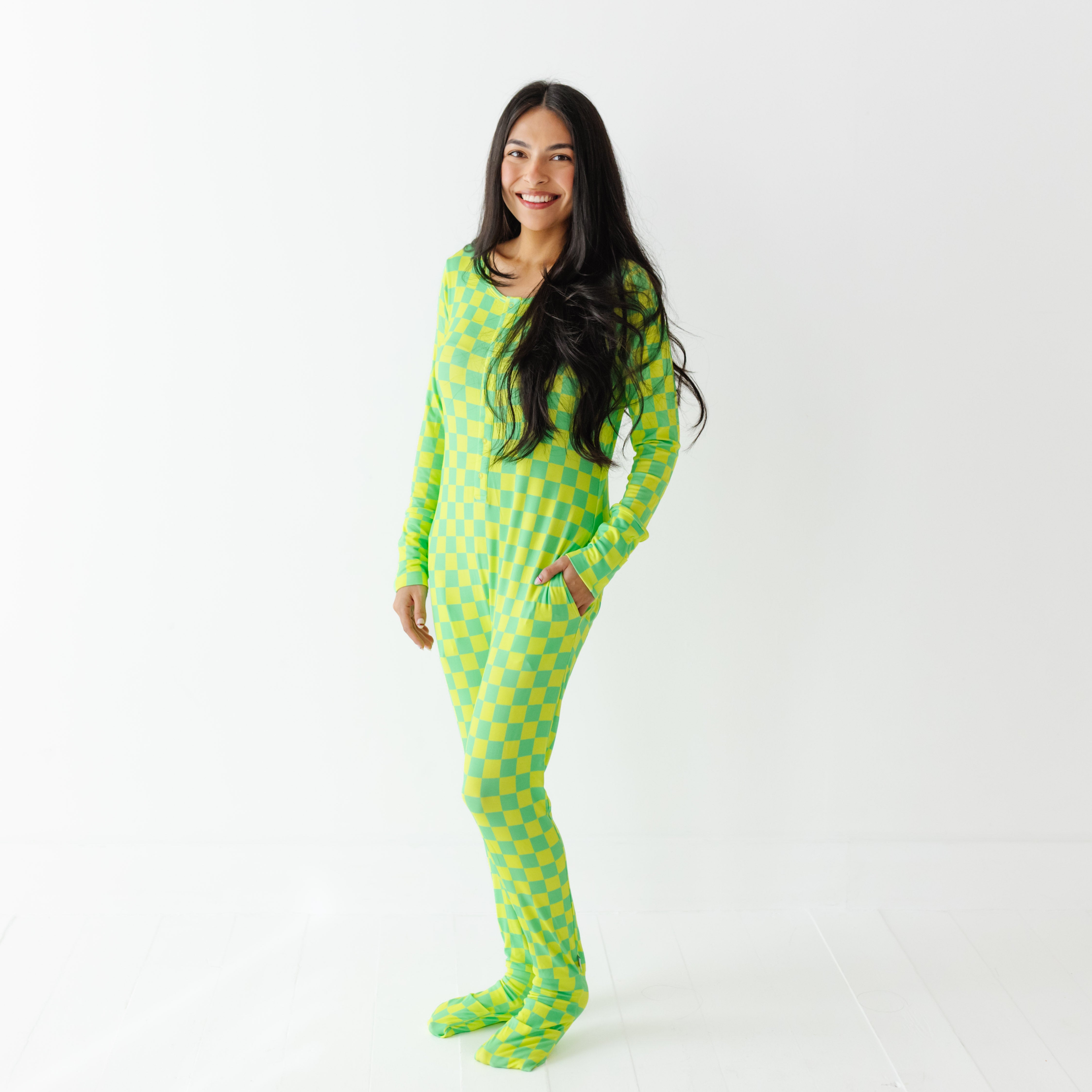 Woman wearing a green and yellow checkered onesie on a white background