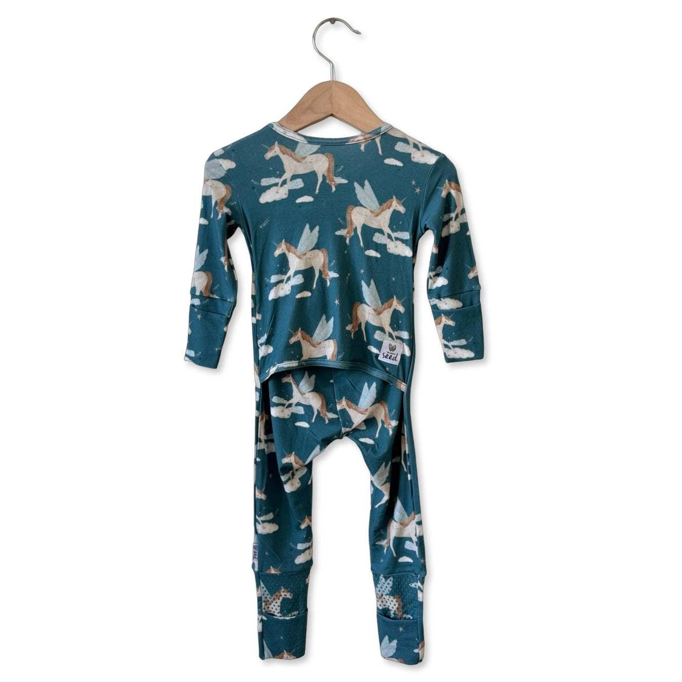 Children's pajama set with unicorn pattern on a hanger against a white background