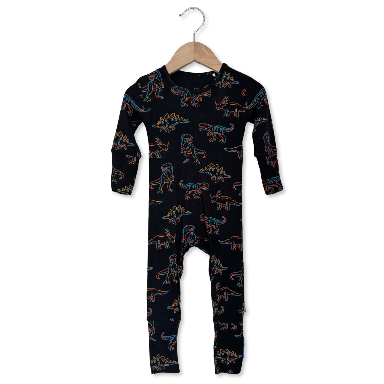 Black onesie with dinosaur pattern on a hanger against a white background