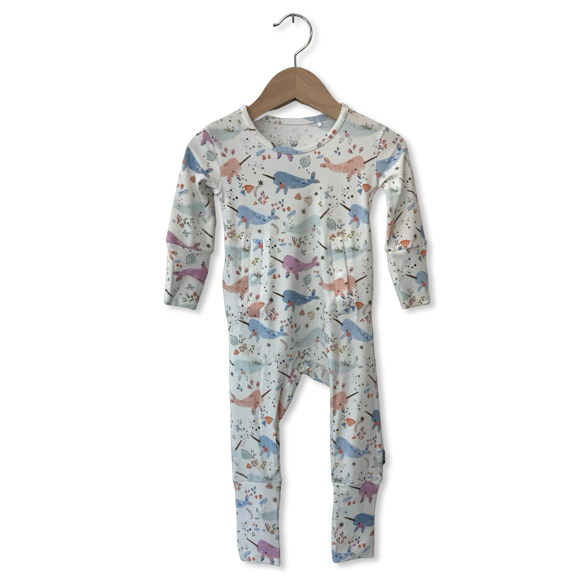 Children's onesie with animal pattern on a hanger against a white background
