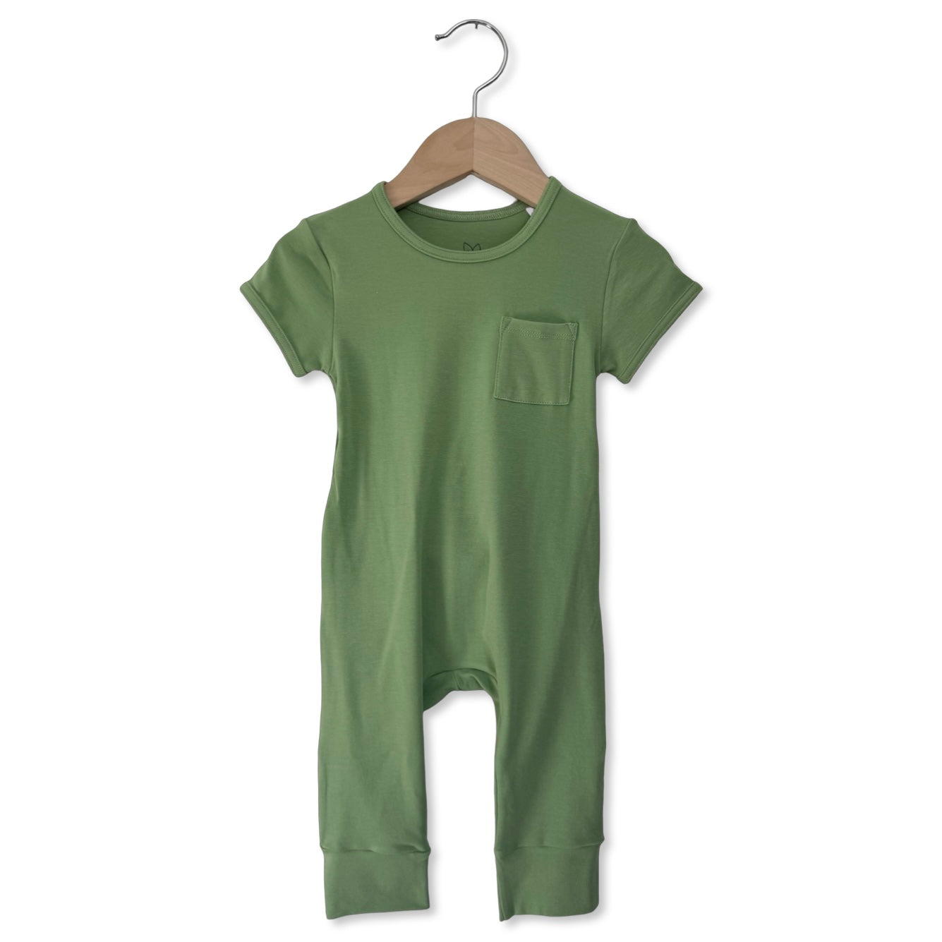 Green baby romper on a hanger against a white background