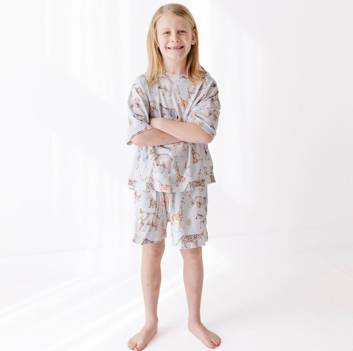 Young boy wearing a patterned outfit on a white background