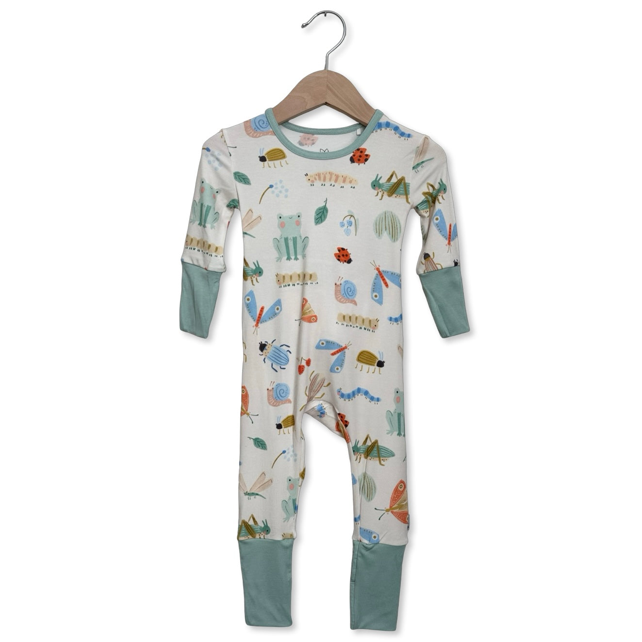Children's onesie with animal pattern on a hanger against a white background
