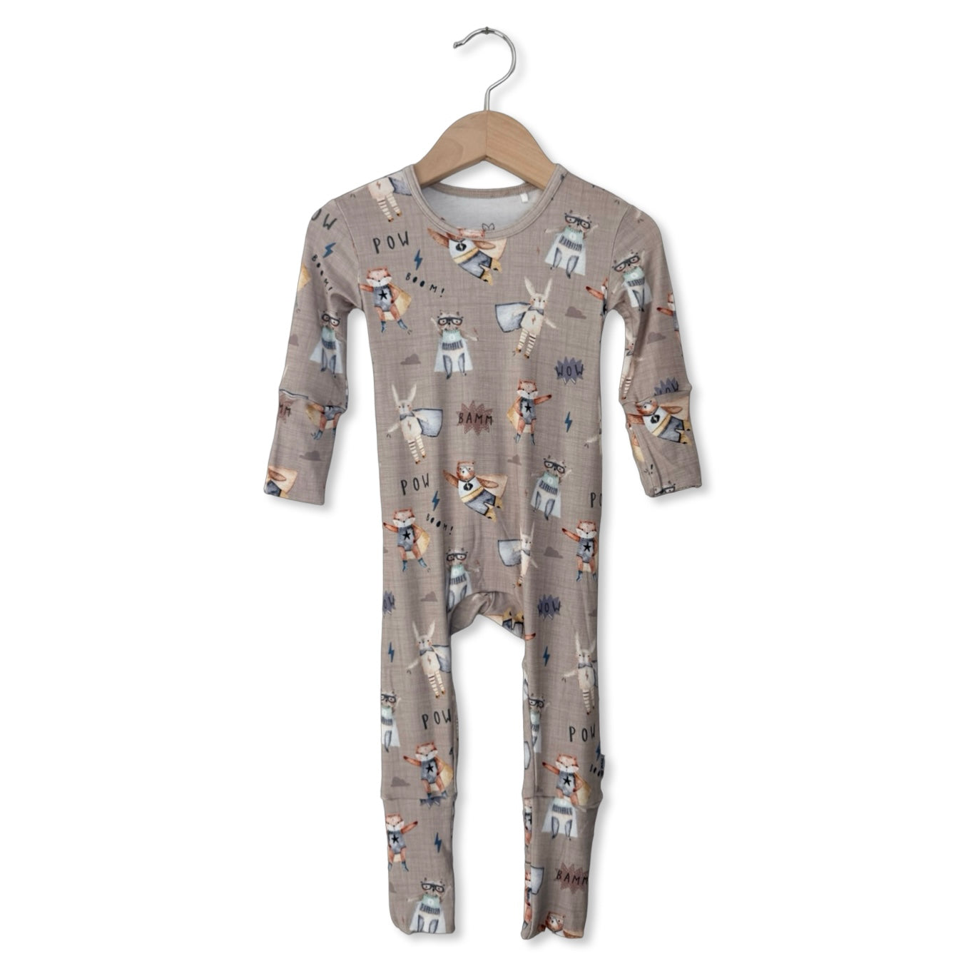 Baby onesie with animal pattern on a hanger against a white background