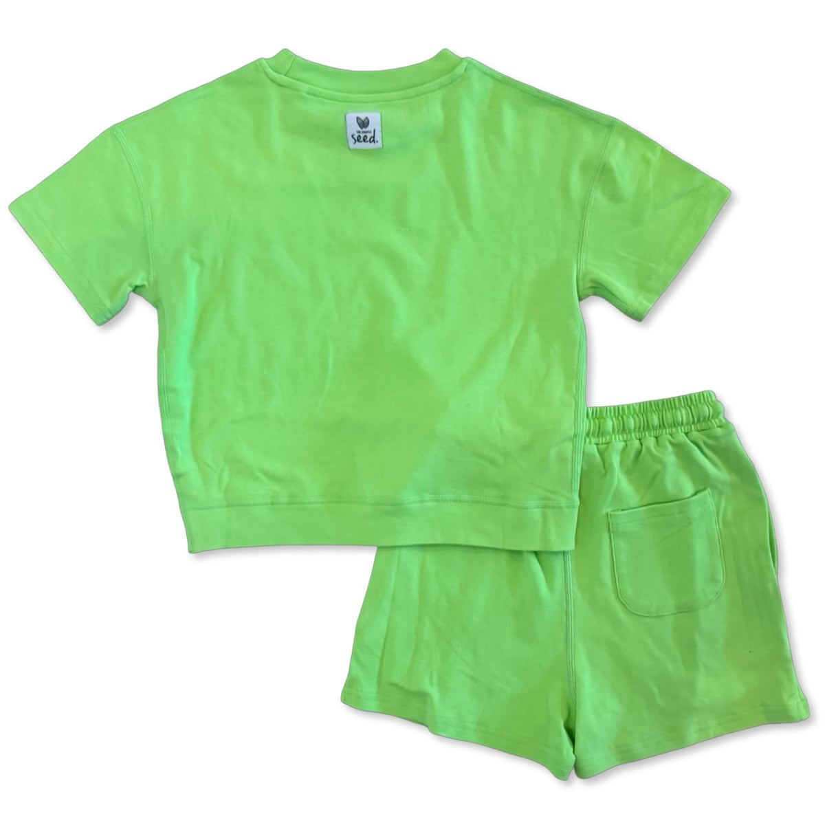 Green t-shirt and shorts set on a white background