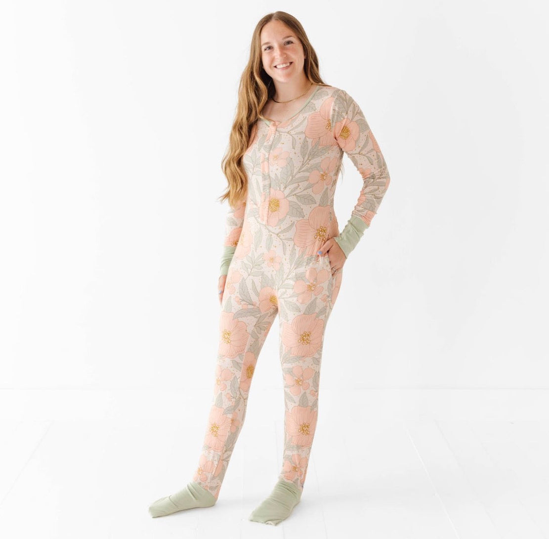 Woman wearing a floral patterned onesie on a white background
