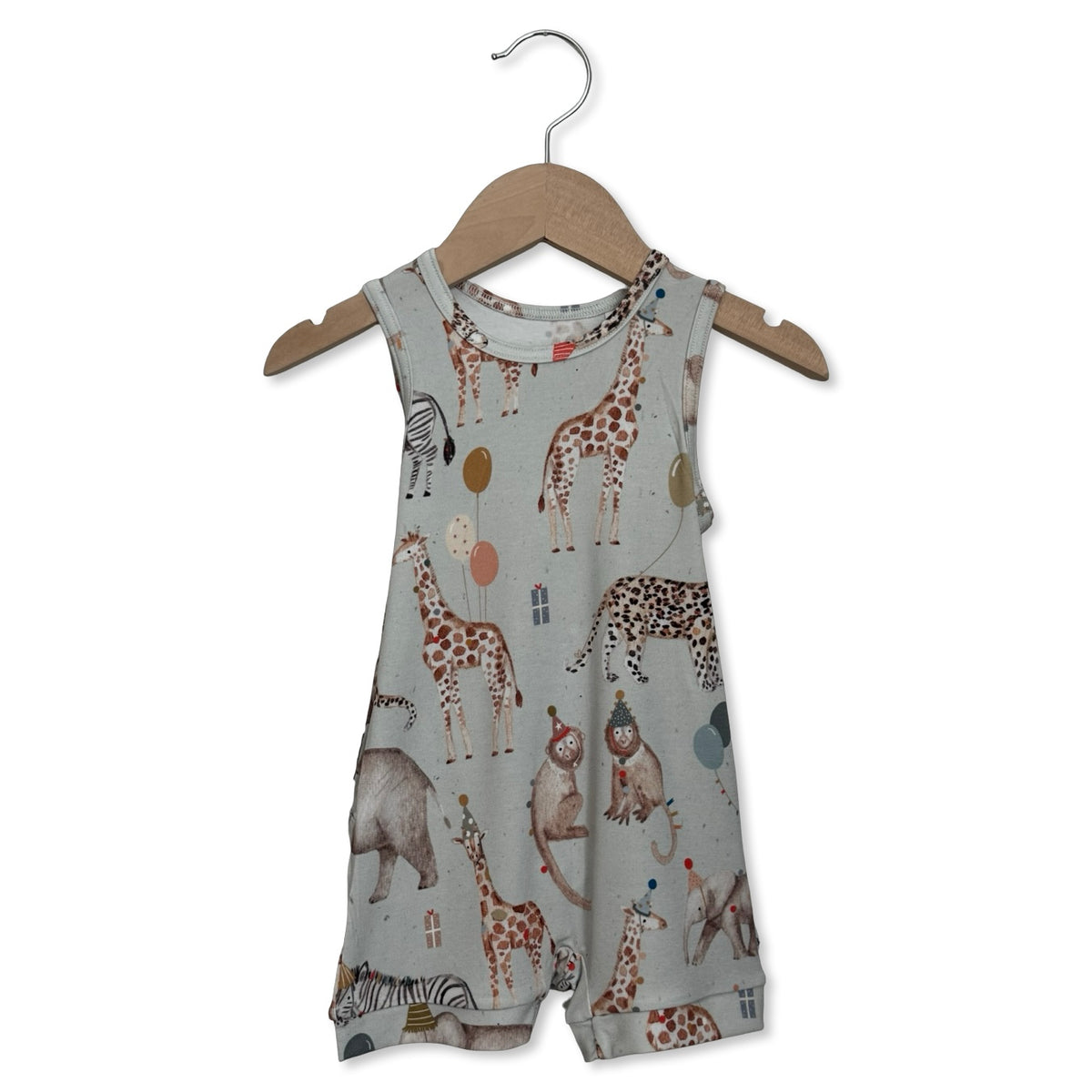 Children's romper with animal pattern on a hanger against a white background