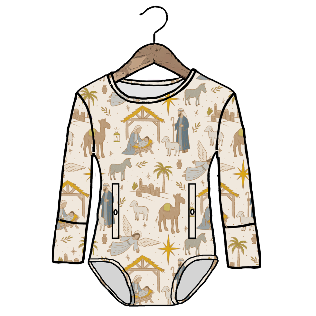 A long-sleeve baby bodysuit with an all-over Nativity scene print, shown hanging on a wooden hanger against a plain white background. The bodysuit features illustrations of camels, shepherds, angels, and star motifs on a light cream base, with a small front zipper pocket on the left side.