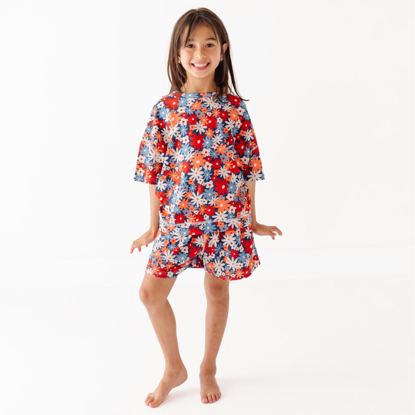 Child wearing a colorful floral dress on a white background