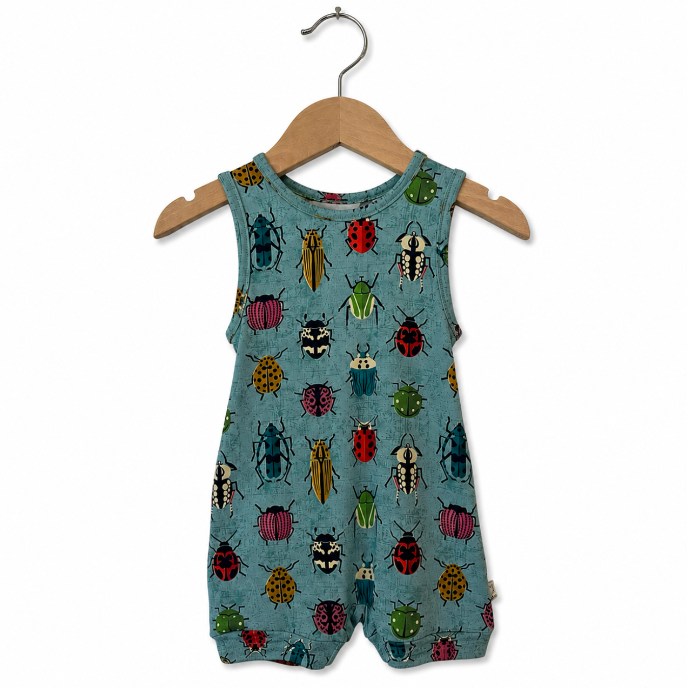 Children's romper with insect pattern on a hanger against a white background