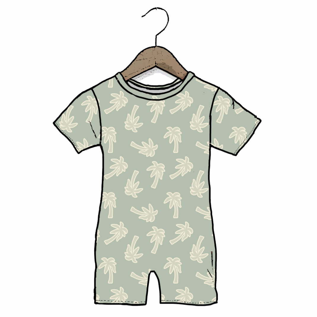A short-sleeve baby romper in a pale sage green color, featuring an all-over cream palm tree pattern. It is shown hanging from a wooden hanger against a plain white background.